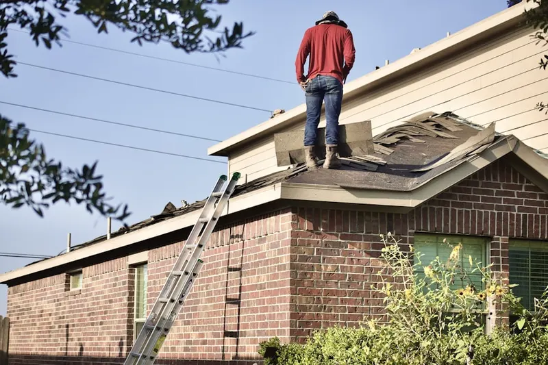 Professional roofer working on a residential roof in Downtown Ansonia